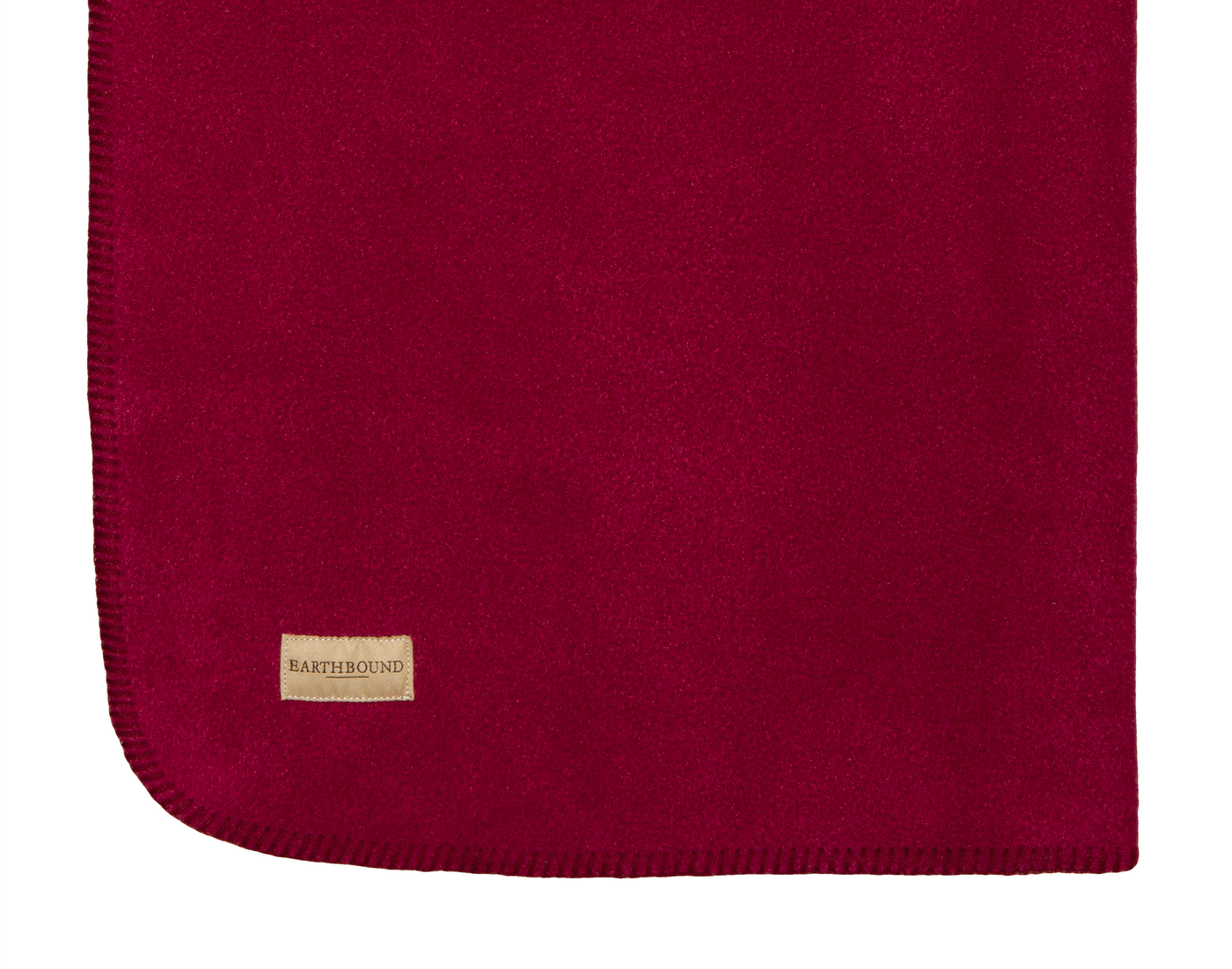 Close up of stitched fleece pet blanket in burgundy and burgundy thread