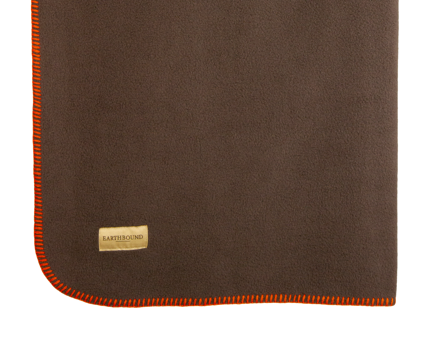 close up of a brown stitched fleece pet blanket with orange thread