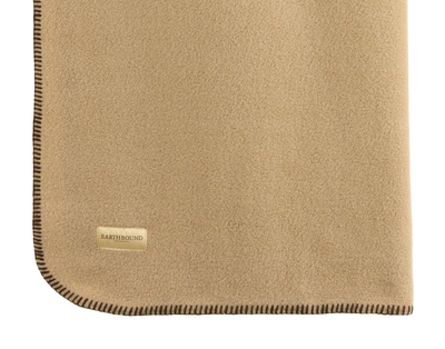 Close up of stitched fleece pet blanket in camel and brown thread