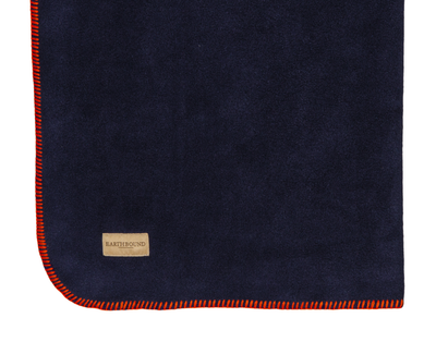 Close up of stitched fleece pet blanket navy and orange thread