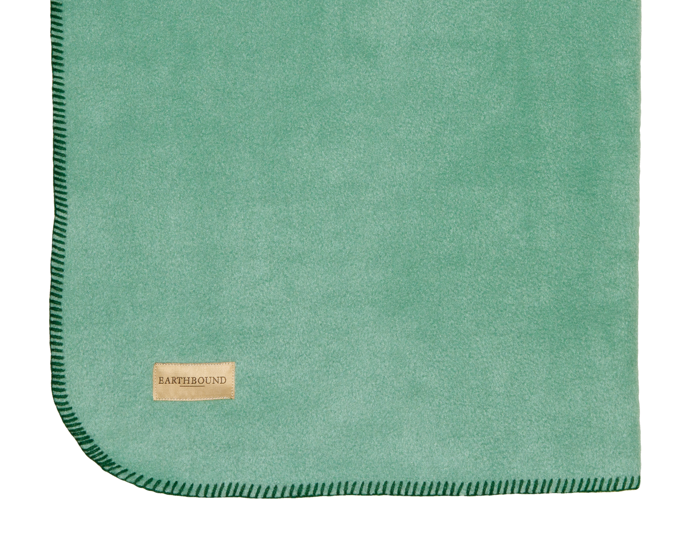 Close up of stitched fleece pet blanket in light green and green thread