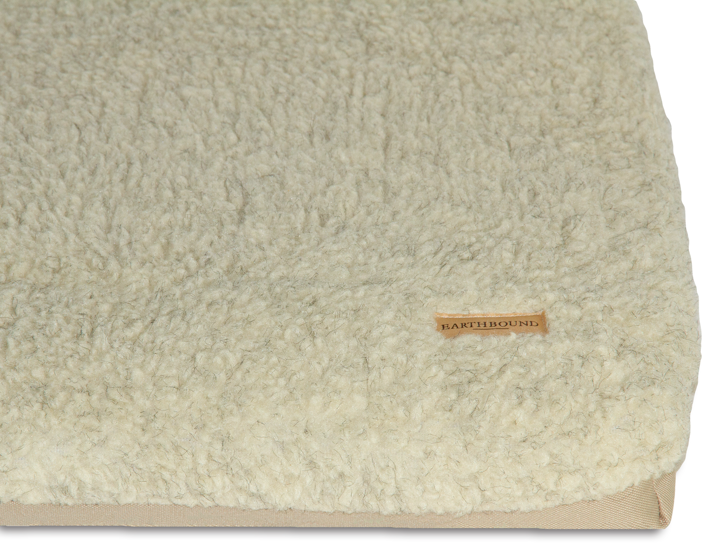 close up of waterproof beige dog crate mat with removable sherpa cover 