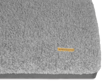 close up of waterproof grey dog crate mat with removable sherpa cover
