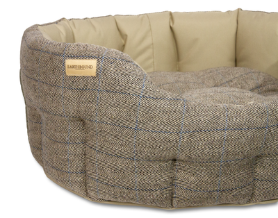 Close up of traditional tweed beige waterproof classic dog bed