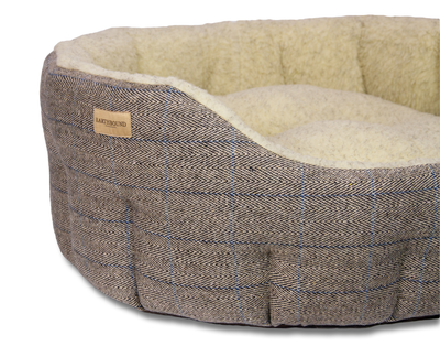 Close up of traditional tweed beige classic dog bed